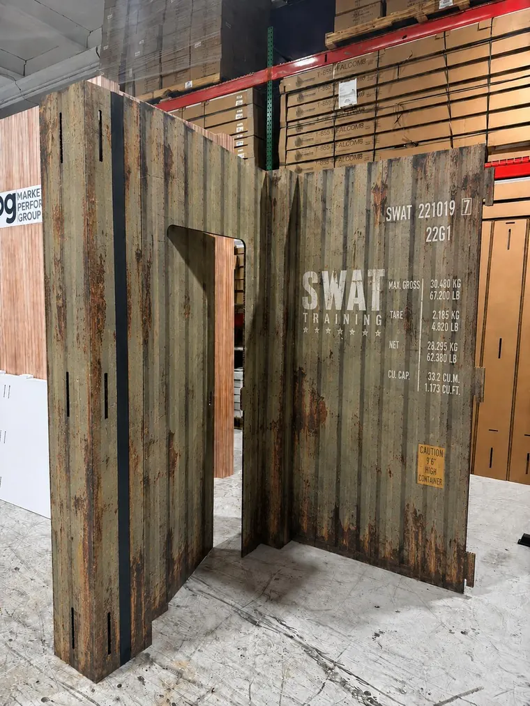 Assembled door and wall printed with a weathered shipping container texture